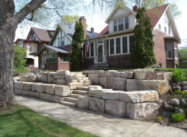 Minneapolis boulder retaining wall with natural stone steps in the city