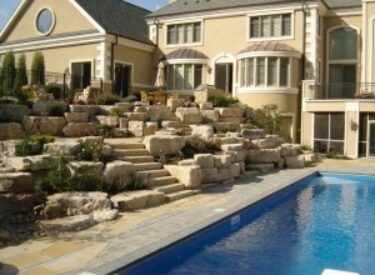 Boulder wall and natural Stone steps around the pool