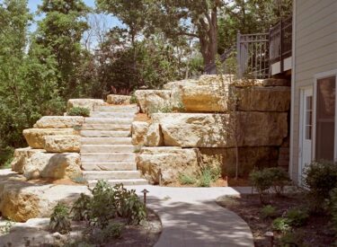 Stone stair case with retaining wall