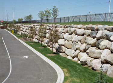 Boulder retaining wall along road
