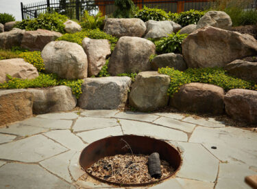 Boulder retaining walls with firepit 1