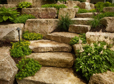Natural stone steps in boulder retaining wall and plants 1